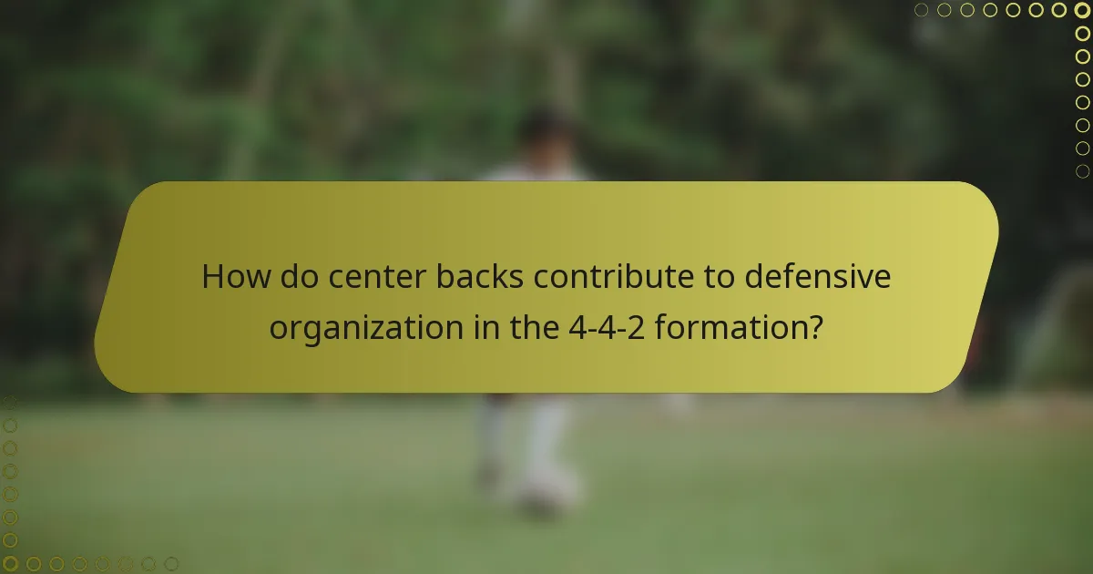 How do center backs contribute to defensive organization in the 4-4-2 formation?