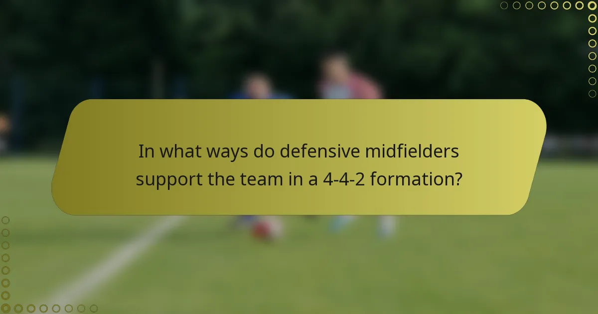 In what ways do defensive midfielders support the team in a 4-4-2 formation?